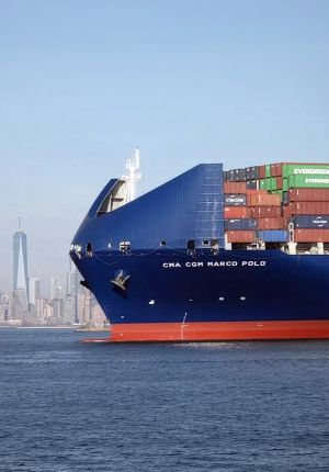 The bow of the container ship loaded with stacked containers.