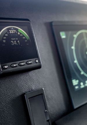 Close-up of a vessel helm display with a radar screen beside it.